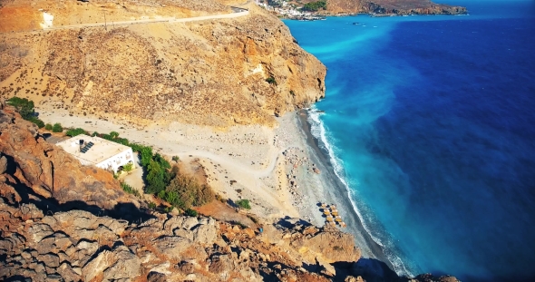 Blue Sea, Waves Breaking in Cliffs at Shore