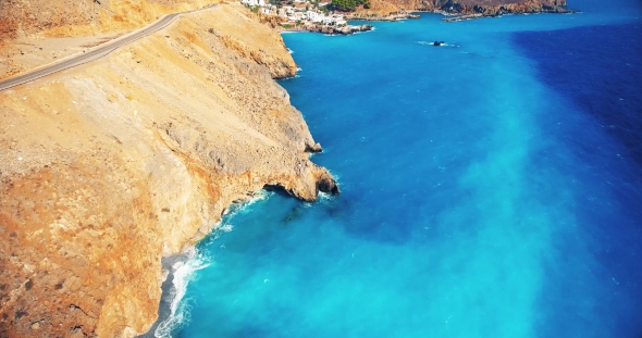 Blue Sea, Waves Breaking in Cliffs at Shore