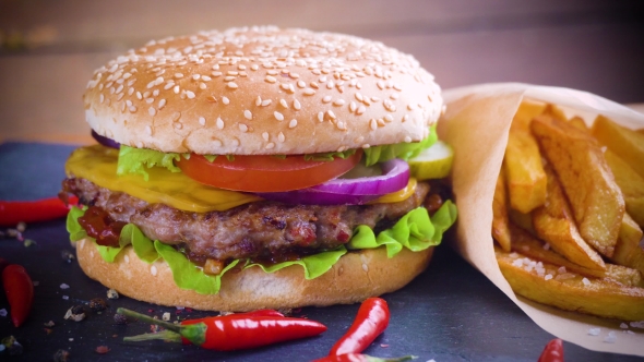 Tasty Homemade Hamburger with Potatos Served on Stone Plate