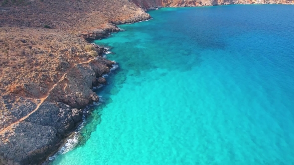 Blue Sea, Waves Breaking in Cliffs at Shore