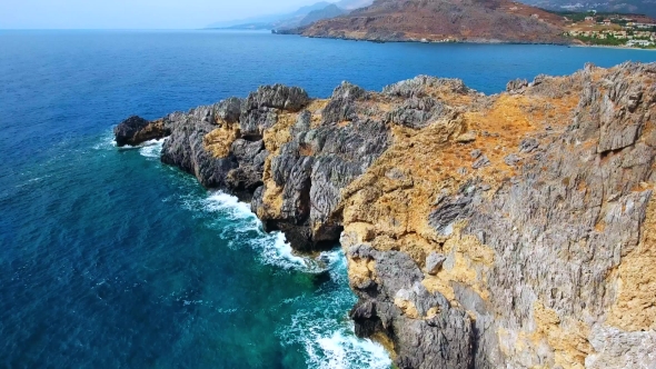 Blue Sea, Waves Breaking in Cliffs at Shore