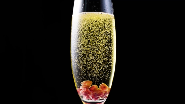Pomegranate Seeds in a Glass of Champagne