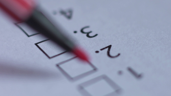 Cropped of Businessman Writing on Checklist