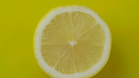 The Cut Lemon on a Yellow Background.