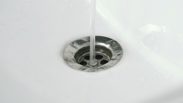 Draining Water Into White Bathtub