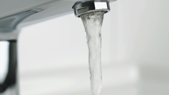 Stream of Water Pouring From Chrome-plated Faucet