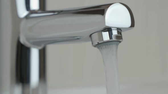 Flow of Water Pouring From Chrome-plated Faucet