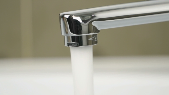 Strong Flow of Water Pouring From Chrome Tap