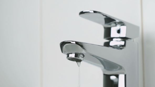 Weak Flow of Water Pouring From Chrome-plated Tap