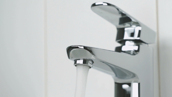 Flow of Water Is Pouring From Chrome-plated Faucet