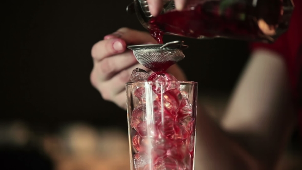 The Bartender Pours the Contents of the Glass alt