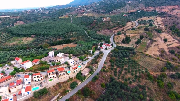 Flying Above Village in Mountains