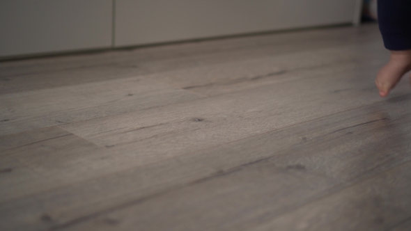 Shot of a Father Teaching His Son To Walk alt