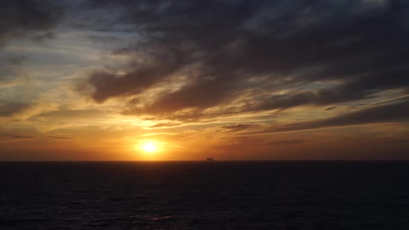 Ship cruising on sunset in the mediterranean sea. Realtime video alt