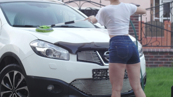 Beautiful Girl Washes the Car Brush