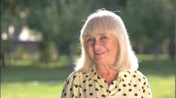 Senior Woman Smiling at Camera alt