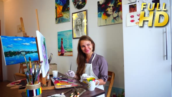 Portrait of Artist Sitting at Easel. Mixes Paints