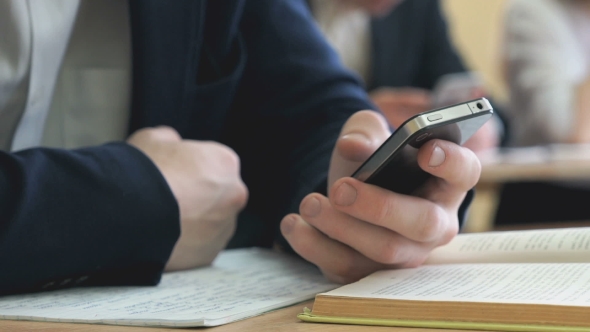 Student Writes the Text Using a Cellphone