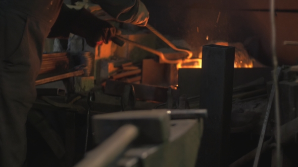 Blacksmith Works in His Workshop