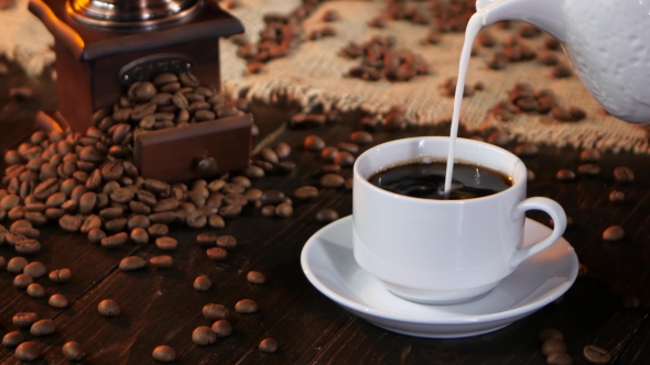 In Cup of Black Espresso Poured Fresh Milk or Cream alt