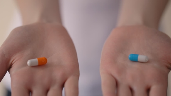 Woman Hands Holding Two Pills