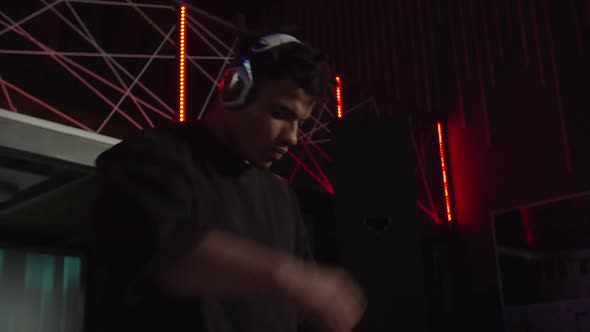 Positive African American Male Dj Playing Electronic Music and Cheering Up Crowd at Nightclub alt