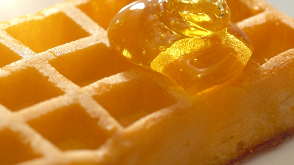 Baked Golden Waffle and Sweet Pouring Honey