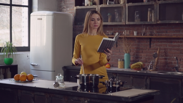 Young Lady Cooks Some Meal. alt