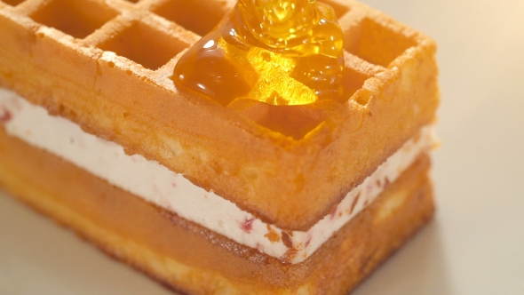 Pouring Honey on Waffles