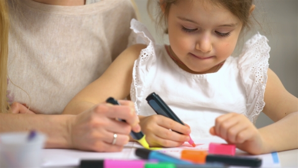 Little Girl Draws in the Nursery.