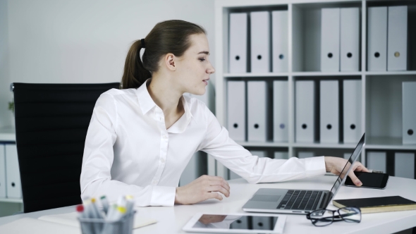 Young Woman Is Working on Computer at Office
