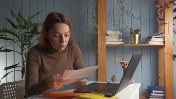 Woman Sit at Workplace Desk and Read Awful News alt