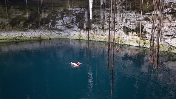 Girl Swimming in Open Cenote