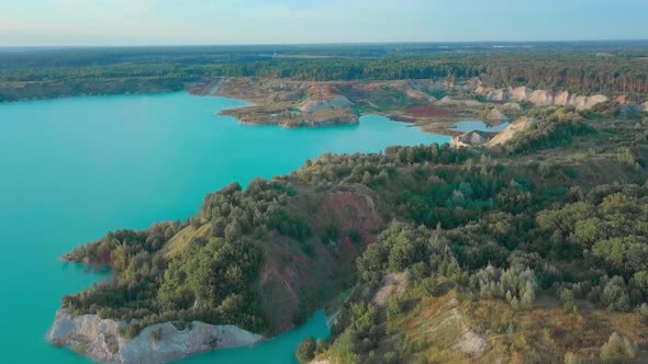 An artificial lake in chalk quarry. view from drone. Turquoise water background alt
