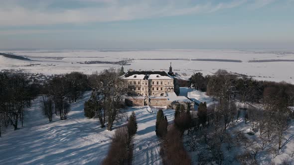 Aerial View Drone Flight Forward Over the Historic Old Castle at Sunny Winter Day Pidhirtsi Palace