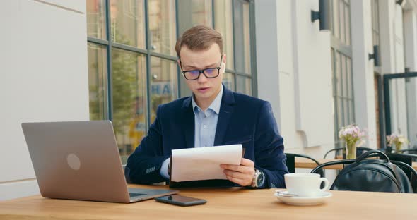 A Businessman Is Discussing Business Issues at a Meeting Via a Video Call on a Laptop alt