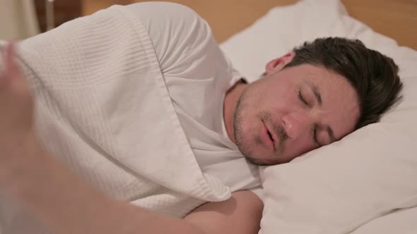 Middle Aged Man Waking up from Nightmare in Bed alt