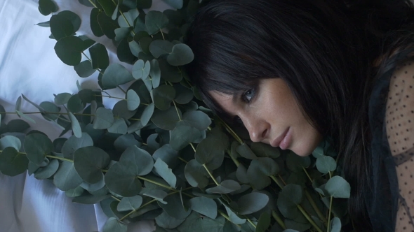 Woman with Eyes Closed with Flower Bunch
