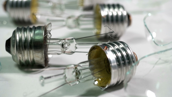 Broken Light Bulbs and Glass on a White Background alt