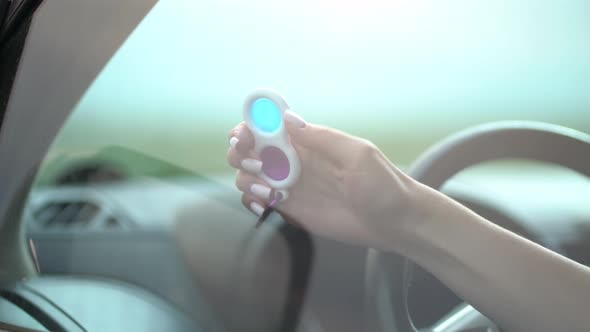 Woman Using Pop It or Simple Dimple in Car