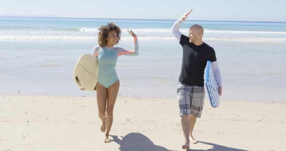 People Cheering Each Other on Beach alt