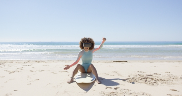 Female on Beach Wearing Virtual Reality Glasses