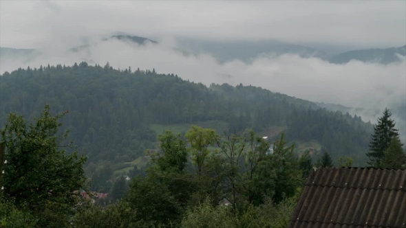 The Awesome View of the Clouds Running Above the Forests in the Mountaints. alt