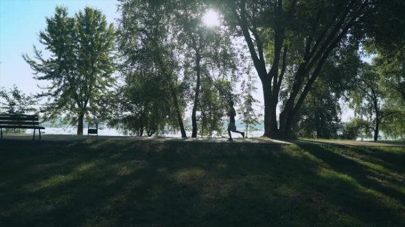 A Fit Guy Is Jogging Outside, From Right To Left. alt