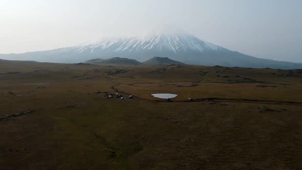 meadows overlooking a snowy volcano