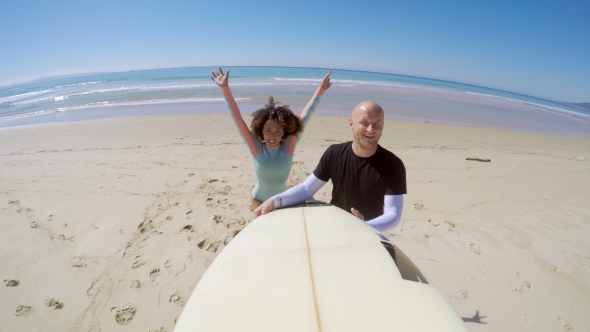 Cheerful Couple with Surfboard alt