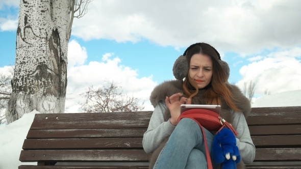 Beautiful Girl with a Phone in Winter alt