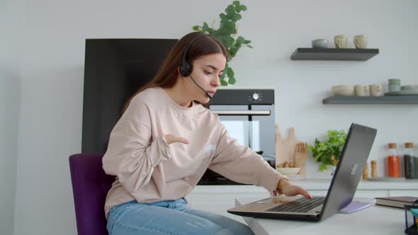 Pretty Woman with Birth Anomaly in Headset Giving Online Customer Support Indoor alt