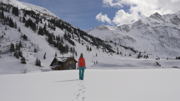 Woman Goes To a Lodge in the Alps