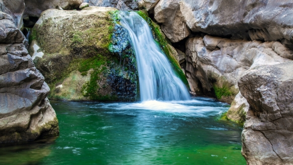 Waterfall Flowing Down a Stone in a Mountain River alt